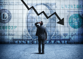 Businessman Looking Up At a Chart That Indicates A Falling U.S. Dollar