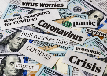Coronavirus, covid-19 news headlines on United States of America 100 dollar bills. Concept of financial impact, stock market decline and crash due to worldwide pandemic