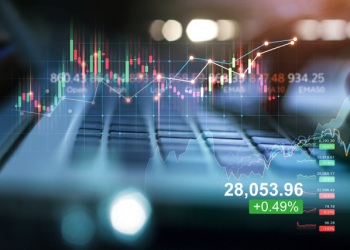Double exposure of forex graph growth. Stock market. Businessman using laptop of financial data analysis on blue background.