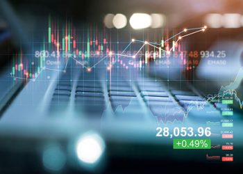 Double exposure of forex graph growth. Stock market. Businessman using laptop of financial data analysis on blue background.