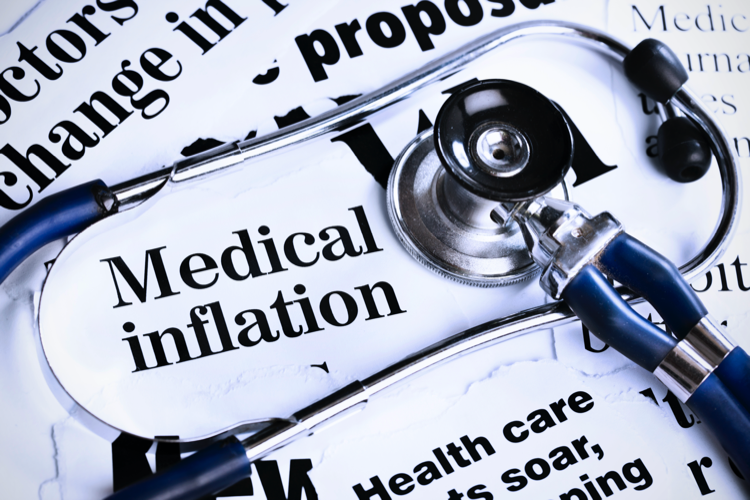 Stethoscope sits on newspaper headlines about medical inflation