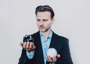 Businessman with black and white piggy bank.