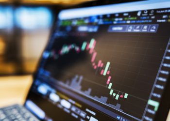 businessman using a laptop to check stock market data