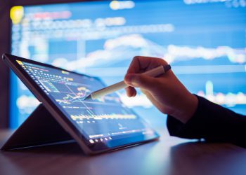 Woman looking stock market Data on smart phone