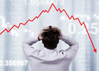 Businessman standing in front of the panel with financial statistics