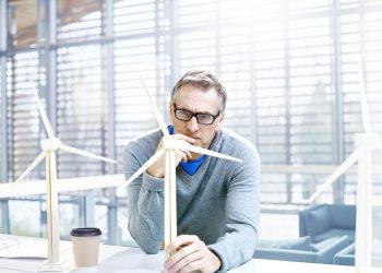 Designer thinking about sustainable energy ideas.