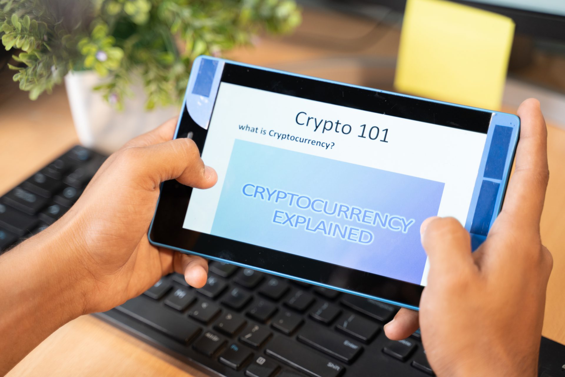 Shoulder shot of unrecognizable man reading or learning about cryptocurrency on tablet