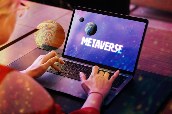 Metaverse concept.Woman using laptop with planet screen