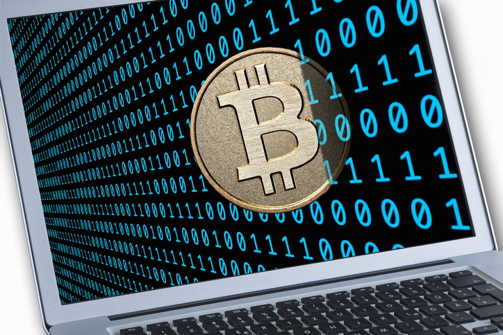 This is a visualization of a Bitcoin together with binary bode on a notebook display. Bitcoin (BTC) is a decentralized digital currency.