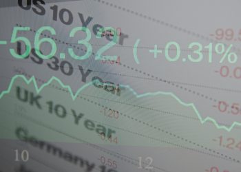 Macro photo of trading terminal on PC monitor. Financial data on PC screen. Multiple exposure.