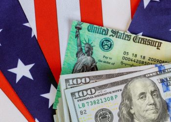 USA dollar cash banknote stimulus economic tax return check with US flag