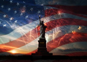 Statue of Liberty on the background of flag usa, sunrise and fireworks