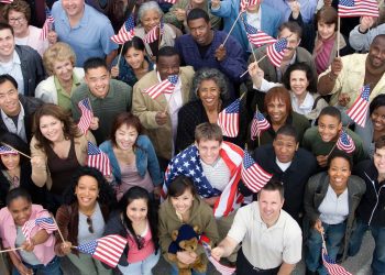 Crowd holding American flags