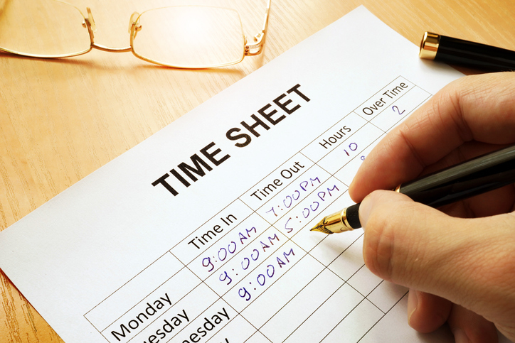 Records work hours in a time sheet.